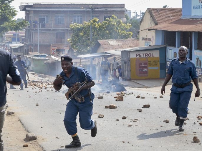 Police try to disperse a crowd of angry residents, after a man was killed by police and relatives were initially prevented from burying him in a timely manner in accordance with his Muslim beliefs, causing anger in his neighborhood, although permission for the burial was later granted, in the Buyenzi area of the capital Bujumbura, in Burundi Wednesday, June 10, 2015. Burundi's controversial presidential elections are now set for July 15. (AP Photo/Gildas Ngingo)