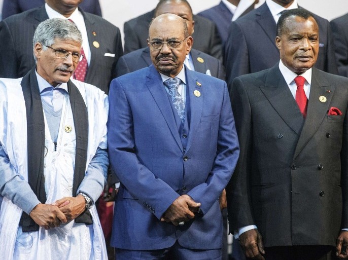President Omar al-Bashir (C), Congo's president Denis Sasso-Nguesso (R) and Prime Minister of the Sahrawi Arab Democratic Republic Abdelkader Taleb Oumar (L) pose during a photo call at the 25th African Union Summit in Sandton South Africa on June 14, 2015. Sudanese President Omar al-Bashir joined a group photograph of leaders at the African Union summit in Johannesburg on Sunday despite the International Criminal Court calling for him to be arrested at the event. Wearing a blue suit, he stood in the front row for the photograph along with South African host President Jacob Zuma and Zimbabwe's President Robert Mugabe, who is the chair of the 54-member group.