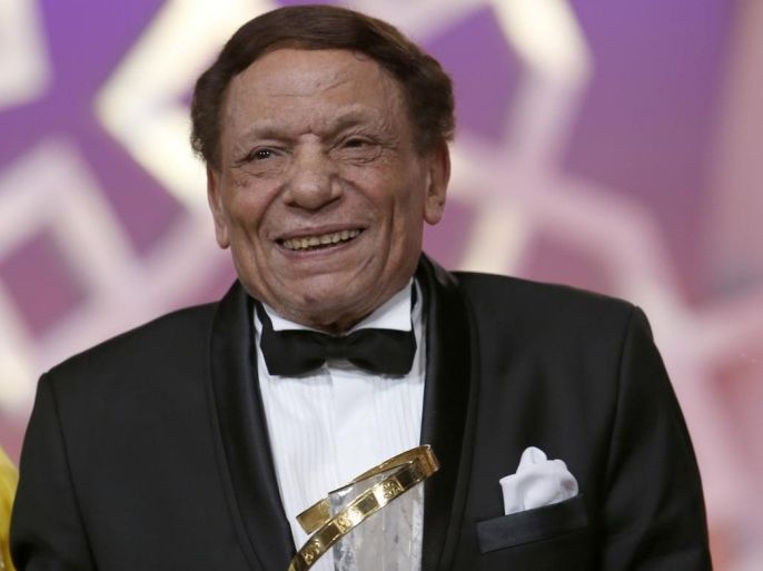 Egyptian actor Adel Imam poses with a trophy in tribute to his lifetime career during the opening ceremony, at the Marrakech International Film Festival in Marrakech, Friday, Dec.5, 2014. The Film Festival will run until Dec.13. (AP Photo/Abdeljalil Bounhar)