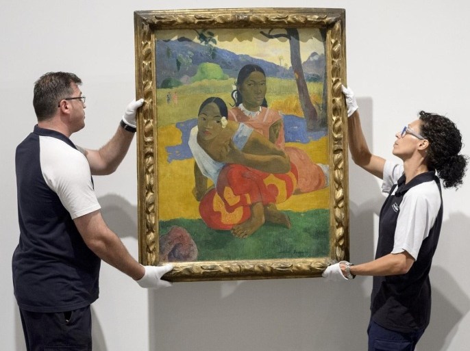 RESTRICTED TO EDITORIAL USE, MANDATORY MENTION OF THE ARTIST UPON PUBLICATION, TO ILLUSTRATE THE EVENT AS SPECIFIED IN THE CAPTIONTwo employees of the Reina Sofia Museum install Paul Gauguin's 'Nafea Ipoipo faa' (When Will You Marry?), the most expensive painting ever sold, in Madrid on July 3, 2015. Gauguin's painting was reportedly paid privately $300 million (270 million Euros) by Qatar on February 2015. AFP PHOTO/ DANI POZO