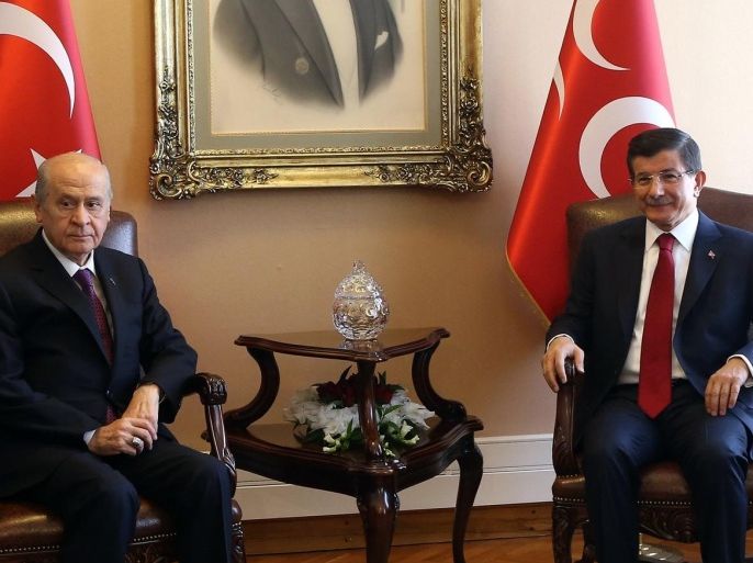 Turkey's Prime Minister Ahmet Davutoglu (R) meets with Nationalist Movement Party (MHP) opposition leader Devlet Bahceli as part of the first round of coalition talks in Ankara, Turkey, on July 14, 2015. Turkish Prime Minister Ahmet Davutoglu began coalition talks on July 13 with the second-placed CHP party after last month's election which saw his ruling party lose its overall majority. Davutoglu's Justice and Development Party (AKP) failed to secure enough votes in the June 7 election to form a government alone, for the first time since it came to power in 2002. AFP PHOTO / ADEM ALTAN