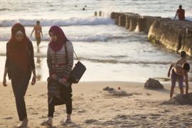 Muslim women stroll after bathing in the Mediterranean sea during the first day of the Eid al-Fitr holiday as the sun sets in Tel Aviv, Israel, Friday, July 17, 2015. The three-day holiday marks the end of the holy fasting month of Ramadan. (AP Photo/Ariel Schalit)