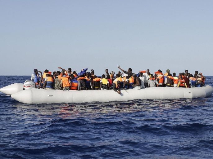 A large number of illegal migrants on board a large dinghy-type vessel after they were rescued by the crew of the ship Euro Mediterranean Sea South, 7 September 2014. The migrants are of sub-Sahara origin and rescued as part of the Mare Nostrum operation that Italy launched after some 400 migrants died in two separate boat disasters in October 2013. Italy is struggling to cope this year with a huge increase in the already big flow of migrants to attempt the hazardous crossing from North Africa.