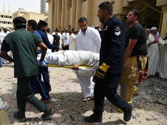 Kuwaiti security personnel and medical staff carry a man on a stretcher at the site of a suicide bombing that targeted the Shiite Al-Imam al-Sadeq mosque after it was targeted by a suicide bombing during Friday prayers on June 26, 2015, in Kuwait City. The Islamic State group-affiliated group in Saudi Arabia, calling itself Najd Province, said militant Abu Suleiman al-Muwahhid carried out the attack, which it claimed was spreading Shiite teachings among Sunni Muslims. AFP PHOTO / STR