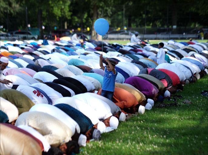 Muslim faithfuls take part in a special morning prayer to start their Eid al-Fitr celebrations on a field at the Prospect Park in Brooklyn borough of New York on July 17, 2015. Muslims across the world are celebrating Eid al-Fitr marking the