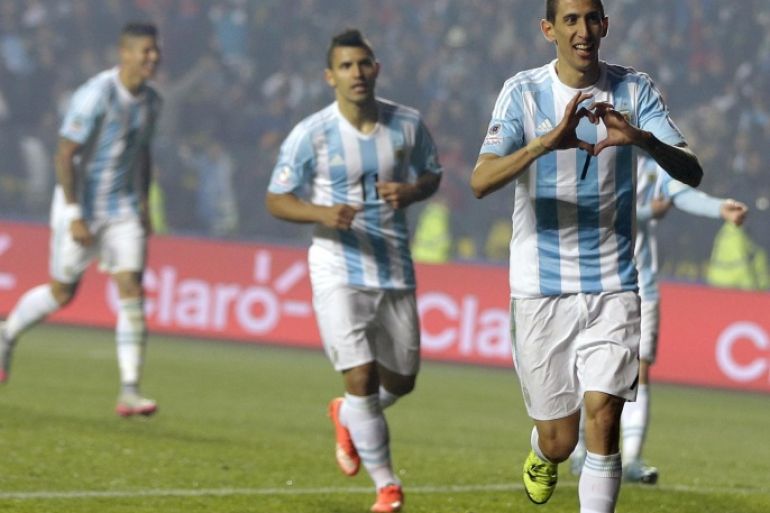 Argentina's Angel Di Maria, right, celebrates after scoring his second goal and his team's fourth against Paraguay during a Copa America semifinal soccer match at the Ester Roa Rebolledo Stadium in Concepcion, Chile, Tuesday, June 30, 2015. (AP Photo/Ricardo Mazalan)