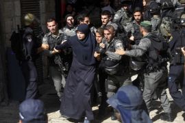 Israeli border police officers scuffle with Palestinian women in the Old City of Jerusalem on Sunday, July 26, 2015. Israeli police said they entered the al-Aqsa Mosque, a holy Jerusalem site, to prevent Arab youths from attacking visiting Jews marking a biblical holiday. (AP Photo/Mahmoud Illean)