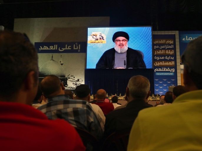 Hezbollah leader Sheikh Hassan Nasrallah speaks on a screen via a video link from a secret place during a rally to mark Al-Quds (Jerusalem) day, in the southern suburb of Beirut, Lebanon, Friday, July 10, 2015. Nasrallah vowed that his group will continue to fight in Syria along with President Bashar Assad's forces saying "the road to Jerusalem passes through Syria." (AP Photo/Bilal Hussein)