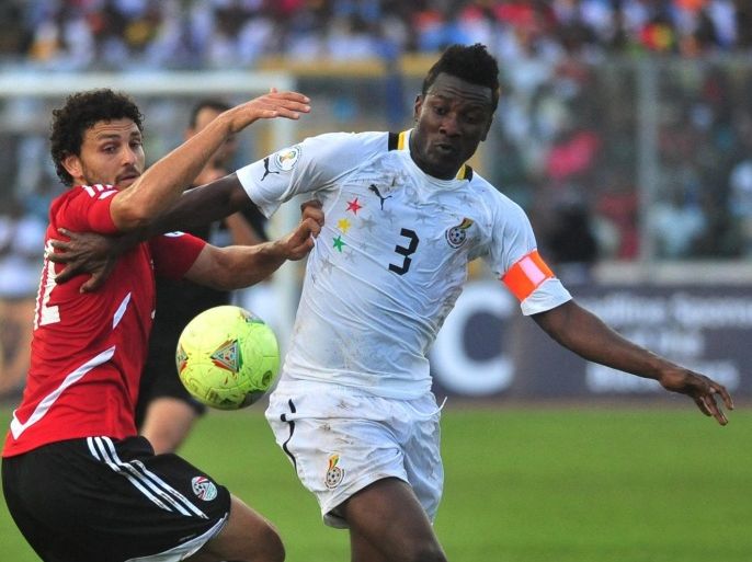 FILE - In this Oct. 15, 2013, file photo, Ghana captain Asamoah Gyan, right, is challenged by Egypt's Hossam Ghaly during their World Cup playoff soccer match in Kumasi, Ghana. (AP Photo, File) - SEE FURTHER WORLD CUP CONTENT AT APIMAGES.COM