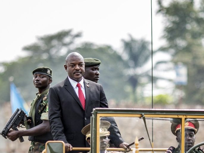 Burundi's President Pierre Nkurunziza (2nd L) arrives in a car for celebrations of the country's 53rd Independence Anniversary at Prince Rwagasore Stadium in Bujumbura on July 1, 2015. Six people including a policeman were killed in gun battles on July 1 in the latest violence in Burundi, as it awaits results from elections boycotted by the opposition and condemned internationally. Elsewhere in the capital, military parades were held to mark the country's independence day. AFP PHOTO / MARCO LONGARI