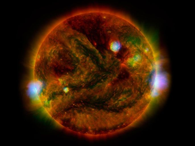 Flaring, active regions of the sun are highlighted in this April 29, 2015 NASA handout satellite image combining observations from several telescopes. High-energy X-rays from NASA's Nuclear Spectroscopic Telescope Array (NuSTAR) are shown in blue; low-energy X-rays from Japan's Hinode spacecraft are green; and extreme ultraviolet light from NASA's Solar Dynamics Observatory (SDO) is yellow and red. REUTERS/NASA/Handout via Reuters