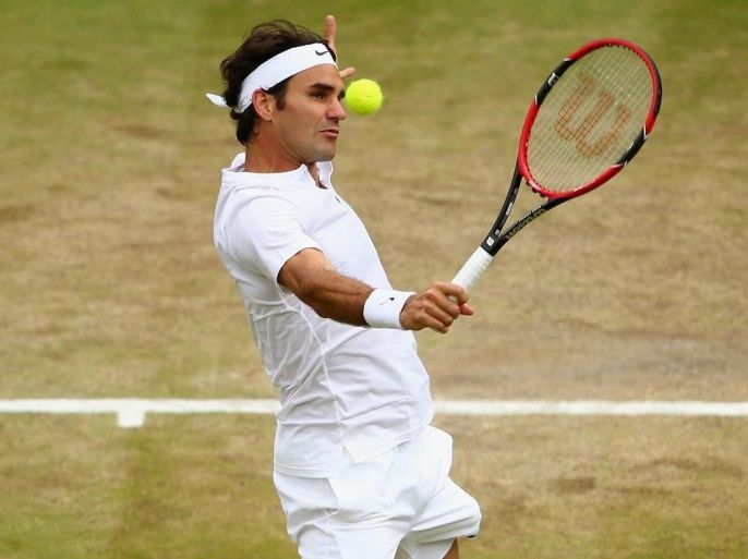 LONDON, ENGLAND - JULY 08: Roger Federer of Switzerland plays a backhand in his Gentlemens Singles Quarter Final match against Gilles Simon of France during day nine of the Wimbledon Lawn Tennis Championships at the All England Lawn Tennis and Croquet Club on July 8, 2015 in London, England.