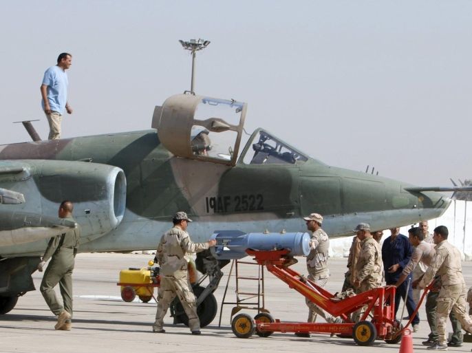 Soldiers reload the Sukhoi Su-25 aircraft at an air base in Baghdad March 26, 2015. Coalition and Iraqi planes struck a sprawling complex of palaces in the city of Tikrit on Thursday where Islamic State militants have been holding out for more than three weeks. Iraq's Defense Minister Khaled al-Obeidi played down the role of Iranian advisers and the degree of interaction between them and the coalition. REUTERS/Khalid al-Mousily