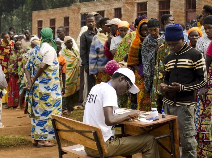 People stand in a long queue to cast their votes at a polling station in Ngozi during a parliamentary election in Burundi June 29, 2015. Burundians voted for a new parliament on Monday after a night of sporadic blasts and gunshots, and weeks of violent protests against President Pierre Nkurunziza's decision to seek a third term in office. REUTERS/Stringer