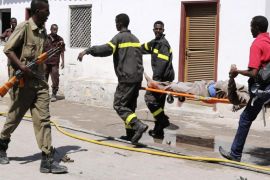 Rescuers carry a survivor from the scene of a blast at the Central Hotel after a suicide attack in Somalia's capital Mogadishu February 20, 2015. Islamist rebels detonated a car bomb at the entrance of the hotel in the Somali capital on Friday and then stormed inside where politicians had gathered, killing at least 10 people including a lawmaker and lightly wounding two ministers. REUTERS/Feisal Omar (SOMALIA - Tags: CRIME LAW CIVIL UNREST)
