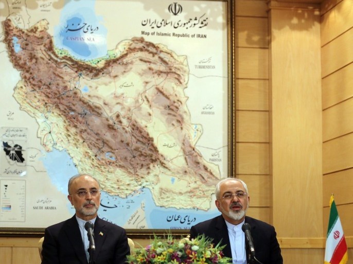 Iranian Foreign Minister Mohammad Javad Zarif (R) and the head of Iran's Atomic Energy Organization Ali Akbar Salehi (L) give a press conference at Tehran's Mehrabad Airport following their arrival on July 15, 2015, after Iran's nuclear negotiating team struck a deal with world powers in Vienna. Iran's negotiating team arrived back home saying a deal with world powers has solved a 'manufactured crisis' over its nuclear programme, while US conservatives bristle at the accord. AFP PHOTO / ATTA KENARE