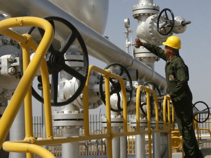 FILE- In this Tuesday, April 15, 2008 file photo, Iranian oil technician Majid Afshari checks the oil separator facilities in Azadegan oil field, near Ahvaz, Iran. When Iran welcomes leaders to a world gathering next week, few will get a grander reception than India's prime minister. As Tehran tries to offset the squeeze from Western oil sanctions, there is no greater priority than courting energy-hungry Asian markets. (AP Photo/Vahid Salemi, File)