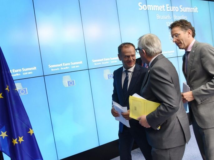 (L-R) EU Council president Donald Tusk, European Commission president Jean-Claude Juncker and Eurogroup chief Jeroen Dijsselbloem leave after a press conference at the end of talks over the Greek debt crisis in Brussels on July 13, 2015. Juncker said there was no longer any risk of Greece crashing out of the euro after Athens agreed a bailout deal with eurozone partners. AFP PHOTO / THIERRY CHARLIER