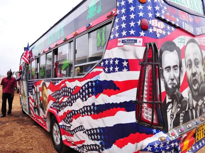 Minibus driver Solomon Murimia calls on clients next to his 'matatu' minibus with a painting depicting US Presidents Abraham Lincoln and Barack Obama and US civil rights activist Martin Luther King on July 22, 2015 in Nairobi. Obama will make his first presidential pilgrimage to his father's homeland of Kenya later this month, the cap to a week-long trip to three key African nations. AFP PHOTO / SIMON MAINA