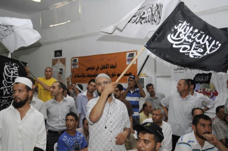 Tunisian Islamist party Hizb Ettahrir's supporters wave flags during a congress organised by the banned Islamist party advocating the restoration of the caliphate, on June 24, 2012 in Tunis.