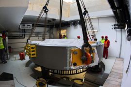 Workers install a component of a more than 220-ton-heavy proton accelerator on a foundation in the new building of the centre for radiotherapy of cancer patients 'Oncoray' at the campus of the medical university in Dresden, Germany, 06 February 2013. The university hospital and the Helmholtz-Zentrum Dresden-Rossendorf announced the same day that the first patients are planned to be treated in spring 2014. The method of using a particle accelerator targets the tumor with a beam of protons. By doing so, the charged particles cause damage to the cells of DNA, resulting in their death or interfering with their ability to grow or multiply by producing new cells.