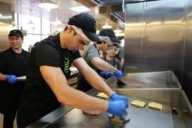 A worker grills hamburger patties at a fryer in the kitchen of the first Shake Shack burger restaurant to open in Moscow, Russia, on Tuesday, Dec. 24, 2013. The New York burger joint known for its queues will sell ShackBurgers for 235 rubles ($7.15), about 50 percent more than in New York and almost triple the price of a local Big Mac.