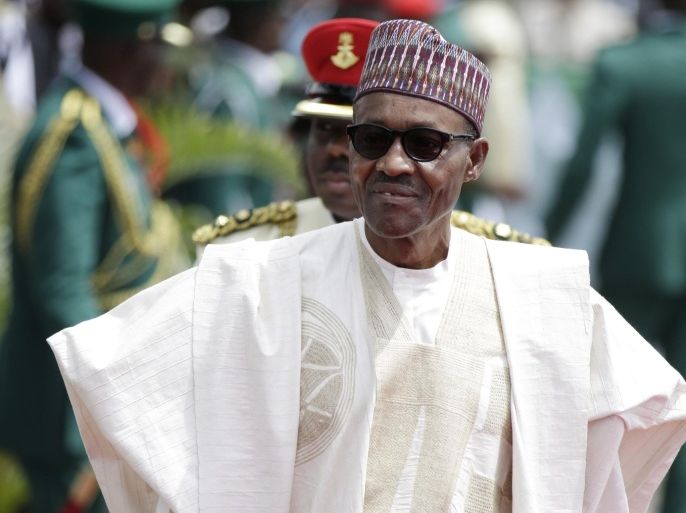 FILE- In this file photo taken Friday, May 29, 2015, former General and Nigerian President, Muhammadu Buhari, arrives for his Inauguration at the eagle square in Abuja, Nigeria. One month after taking office, Nigeria's new president has not yet named a Cabinet to help him cope with this country's firestorm of troubles. (AP Photo/Sunday Alamba, File)