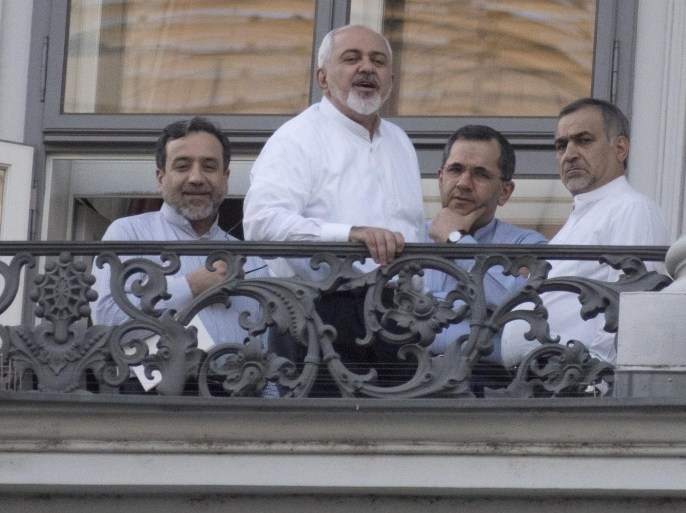 (From L) Iranian Deputy Foreign Minister Abbas Araqchi, Iranian Foreign Minister Mohammad Javad Zarif, Iran's deputy foreign minister for European and American Affairs, Majid Takht-Ravanchi, and Hossein Fereydoun, the brother of the Iranian president gather onto a balcony of the Palais Coburg Hotel, where the Iran nuclear talks meetings are being held in Vienna on July 11, 2015. World powers struggled on July 11 to break a deadlock in marathon negotiations with Iran, as they seek a deal curbing Tehran's nuclear ambitions in return for sanctions relief. AFP PHOTO / JOE KLAMAR