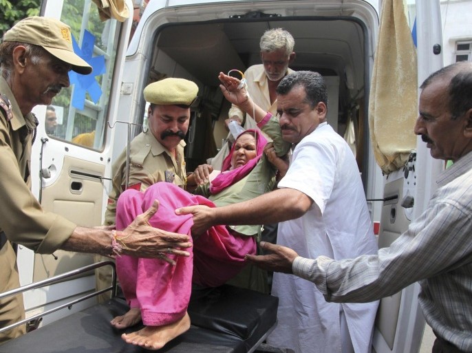 An Indian civilian woman injured in exchange of fire by troops on the India Pakistan border is brought for treatment at the government medical college hospital in Jammu, India, Wednesday, July 15, 2015. Indian and Pakistani troops exchanged fire in the disputed Himalayan region of Kashmir on Wednesday, killing a woman and wounding at least four other people on the Indian side, officials said. (AP Photo/Channi Anand)