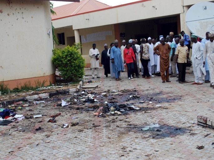 Journalists and other goverment officials gather at the scene of a bomb blast, at Sabon-Gari Local Government Secretariat on the outskirts of the city of Zaria, in Kaduna, Nigeria July 7, 2015. REUTERS/Stringer