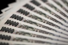 Japanese 10,000 yen banknotes are arranged for a photograph in Tokyo, Japan, on Wednesday, July 22, 2015. The yen slipped 0.1 percent to 124.03 per dollar after better-than-expected data on U.S. housing and a continuing commodity rout boosted the greenback.