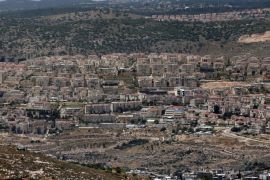 A picture taken from the Israeli settlement of Elazar on May 31, 2015, shows a general view of the settlement of Beitar Illit (background) built in front of the Palestinian West bank village of Nahalin (foreground). AFP PHOTO / THOMAS COEX