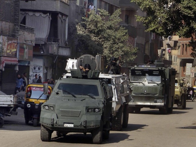 A column of Egyptian security forces' armored vehicles deploy in the Cairo suburb of Matareya on the day that Islamists called for nationwide demonstrations Friday, Nov. 28, 2014. The call for rallies to topple the government and in defense of their religion is their first attempt in months to hold large protests in the face of an overwhelming crackdown since the military's ouster last year of Islamist President Mohammed Morsi.(AP Photo/Ahmed Abdel Fattah) EGYPT OUT