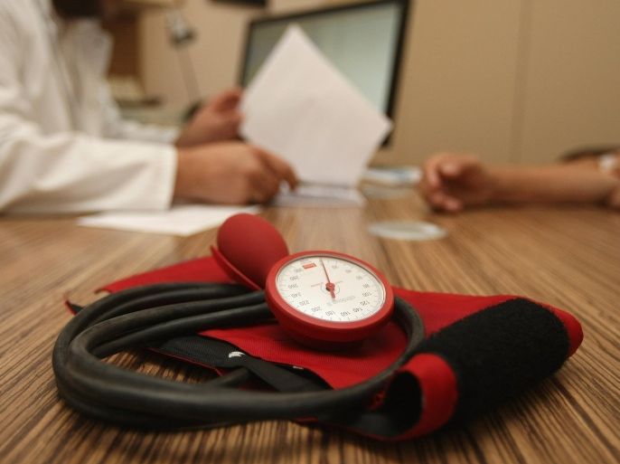 BERLIN, GERMANY - SEPTEMBER 05: A doctor speaks to a patient as a sphygmomanometer, or blood pressure meter, lies on his desk on September 5, 2012 in Berlin, Germany. Doctors in the country are demanding higher payments from health insurance companies (Krankenkassen). Over 20 doctors' associations are expected to hold a vote this week over possible strikes and temporary closings of their practices if assurances that a requested additional annual increase of 3.5 billion euros (4,390,475,550 USD) in payments are not provided. The Kassenaerztlichen Bundesvereinigung (KBV), the National Association of Statutory Health Insurance Physicians, unexpectedly broke off talks with the health insurance companies on Monday.