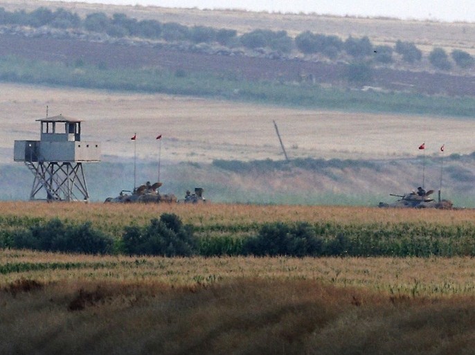 Turkish army tanks hold positions near the border with Syria, in the outskirts of the village of Elbeyi, east of the town of Kilis, in southeaster Turkey, Thursday, July 23, 2015. Suspected Islamic State militants fired at a Turkish military outpost from a region under IS control, inside Syrian territory Thursday, killing a Turkish soldier and wounding two others, an official said. Turkish troops retaliated to the attack and at least one IS militant was killed, amid a surge of violence in Turkey following a suicide bomb attack near Turkey's border with Syria which killed 32 people. (AP Photo/Emrah Gurel)