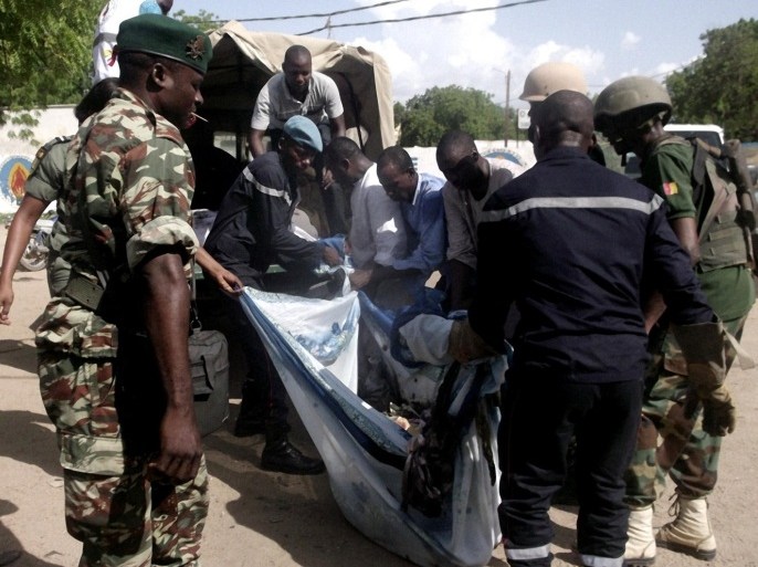 Security forces transport with a blanket the remains of some of the eleven victims of a double blast in the northern Cameroonian city of Maroua on July 22, 2015. Eleven people were killed on Wednesday in northern Cameroon when two girls blew themselves in twin attacks in a region repeatedly targeted by Nigeria-based Boko Haram jihadists, officials said. AFP PHOTO/STRINGER