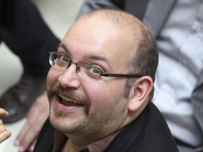 FILE - In this photo April 11, 2013 file photo, Jason Rezaian, an Iranian-American correspondent for the Washington Post, smiles as he attends a presidential campaign of President Hassan Rouhani in Tehran, Iran. The semiofficial Fars news agency says Sunday, April 12, 2015 that the journalist detained in Iran for over eight months is accused of "espionage." Rezaian, who has been held on unspecified charges since July 22, is also facing the charge of "acting against national security."(AP Photo/Vahid Salemi, File)