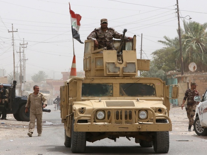 ‪قوات عراقية أثناء معارك سابقة في بيجي‬ قوات عراقية أثناء معارك سابقة في بيجي (غيتي-أرشيف)