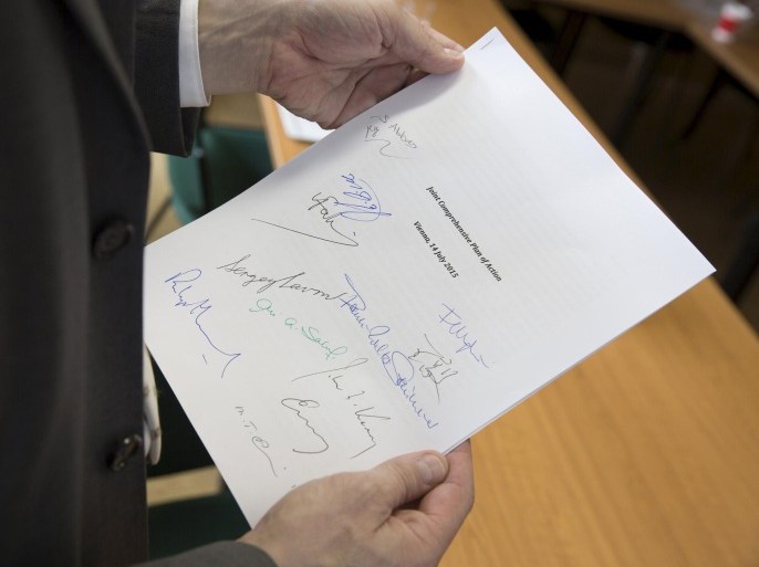 Martin Schaefer, press officer of the German Foreign Ministry holds a signed copy of the Joint Comprehensive Plan of Action regarding Iran's nuclear programme is pictured in Vienna, Austria, July 14, 2015. The United Nations Security Council is likely to vote next week on a resolution to endorse the Iran nuclear deal and terminate targeted sanctions, but retain an arms embargo and ballistic missile technology ban, diplomats said. Picture taken July 14, 2015. REUTERS/Thomas Imo/photothek.net/Auswaertiges Amt/Handout via Reuters TPX IMAGES OF THE DAY ATTENTION EDITORS - THIS IMAGE HAS BEEN SUPPLIED BY A THIRD PARTY. IT IS DISTRIBUTED, EXACTLY AS RECEIVED BY REUTERS, AS A SERVICE TO CLIENTS. FOR EDITORIAL USE ONLY. NOT FOR SALE FOR MARKETING OR ADVERTISING CAMPAIGNS. NO ARCHIVES. NO SALES.