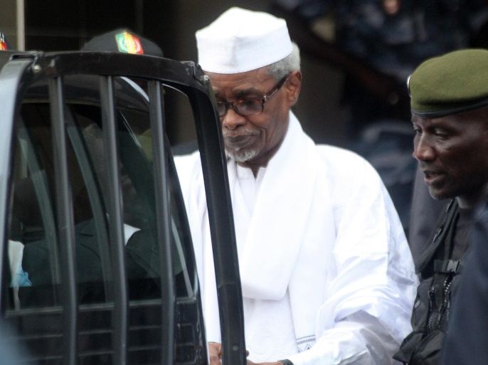 Former Chadian dictator Hissene Habre is escorted by military officers after being heard by judge on July 2, 2013 in Dakar. Senegalese authorities charged Hissene Habre with genocide and crimes against humanity and remanded him in custody on Tuesday in a prosecution seen by many as a milestone for African justice. The 70-year-old was also charged with war crimes and torture during his eight years in power in Chad, where rights groups say 40,000 people were killed under his rule, a court source and his lawyers told.
