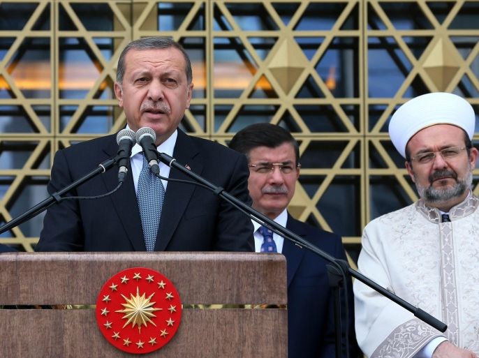 Turkish President Recep Tayyip Erdogan, left, speaks as he inaugurates a mosque on the grounds of his gigantic palace complex and opens it to the public in an apparent effort to stave off more criticism over his spending, in the Bestepe district of Ankara, Turkey, Friday, July 3, 2015. Erdogan, who has been accused of squandering state resources by building the grandiose 1,150-room presidential palace, dedicated the mosque to the people at the opening ceremony, naming it the "Bestepe People's Mosque." Prime Minister Ahmet Davutoglu, centre, and head of Religious Affairs Mehmet Gormez listen.(AP Photo)