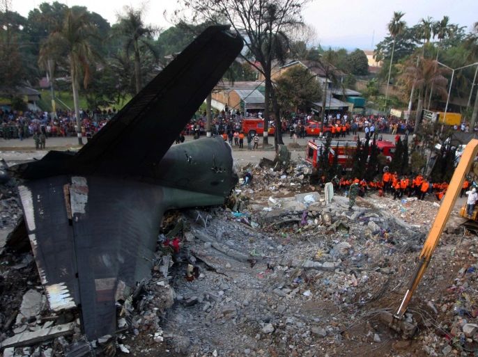 Indonesian rescuers and military personnels examine the wreckage of the crashed C-130 military airplane at the crash site in Medan, North Sumatra, Indonesia, 01 July 2015. According to Indonesian officials at least 141 bodies were recovered after a military plane crashed into Indonesia's third-largest city of Medan just two minutes after take-off. The Hercules C-130 aircraft ploughed into houses and commercial buildings on 30 June 2015, after taking off from the Soewondo airbase in Medan, the capital of North Sumatra province, officials said.