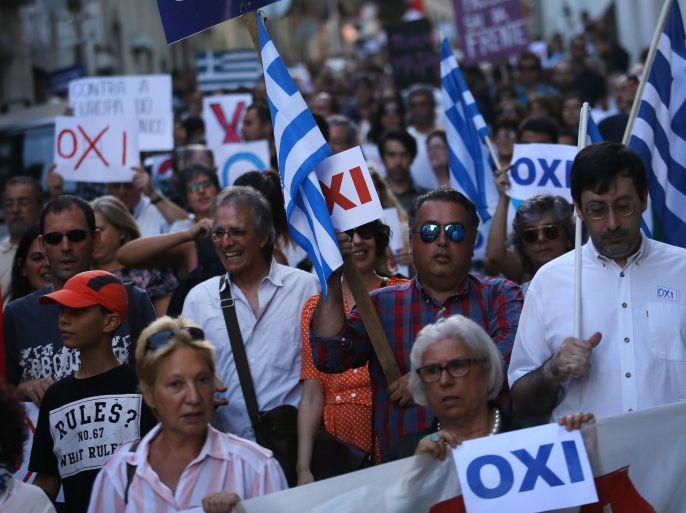 People march during a rally in support to the Greek government, in Lisbon, Saturday, July 4, 2015. Whether Greeks decide in Sunday's referendum to accept their lenders' bailout deal or reject it, the government's hold on power may be shakier than its brash prime minister has calculated, analysts say. White sheets read in Greek: "No", referring to the upcoming referendum, and the blue banner in Portuguese: "Solidarity with Greece". (AP Photo/Francisco Seco)