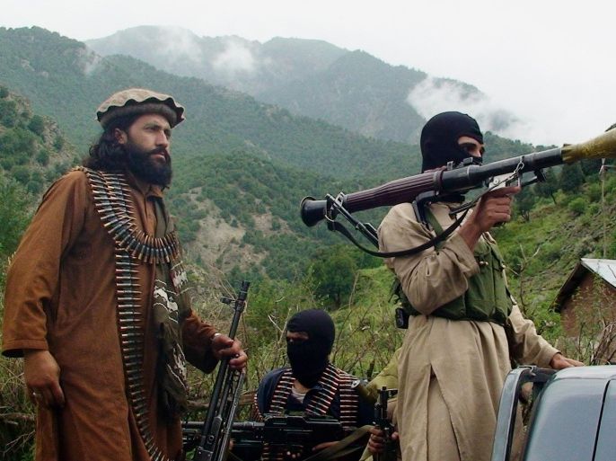 FILE - In this file photo taken on Aug. 5, 2012, Pakistani Taliban patrol in their stronghold of Shawal in Pakistani tribal region of South Waziristan. The chaos unleashed by the Arab Spring has led to the rise of powerful militias -- including many Islamic extremist groups -- across a Middle East where many central governments have been exposed as weak. Some of the groups are allied with such governments, others are fighting to topple them and some -- like the Kurdish peshmerga in northern Iraq -- are seen as vital Western allies. All could prove to be major obstacles to bringing peace or stability to the troubled region. (AP Photo/Ishtiaq Mahsud, File)