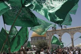 Palestinian Islamist Hamas supporters wave the faction's flag during a demonstration to mark Quds (Jerusalem) day following Friday prayer outside the Dome of the Rock mosque, at the al-Aqsa mosque compound, Islams third holiest site, in Jerusalem's old city on July 10, 2015 on the last Friday of the Islamic holy month of Ramadan. AFP PHOTO / AHMAD GHARABLI