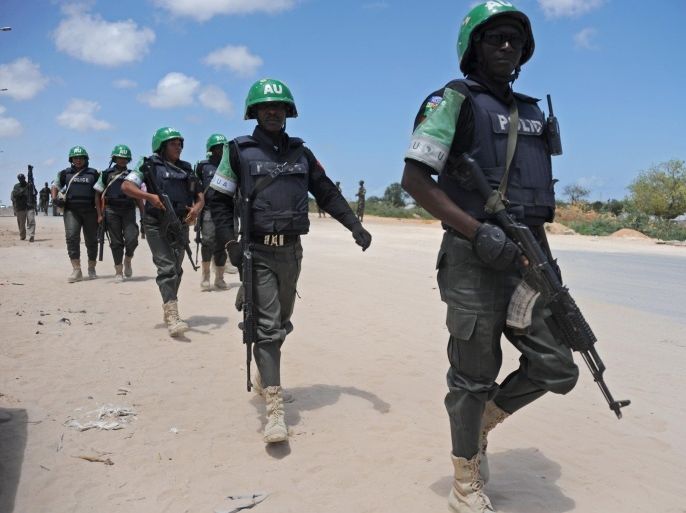 African Union Mission in Somalia (AMISOM) officers patrol around the Gashandhiga academy compound during celebrations of the 55th anniversary day of the Somali military force on April 12,2015 in Mogadishu. AFP PHOTO / MOHAMED ABDIWAHAB