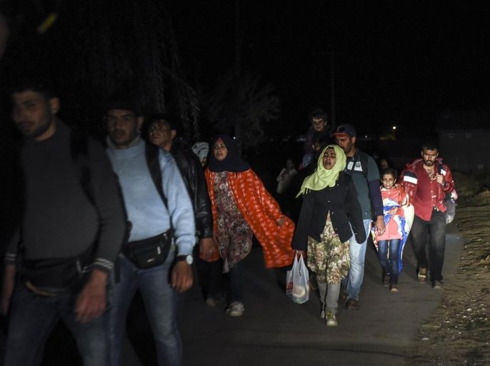 Migrants walk early in the morning near the village Miratovac, in the municipality of Presevo, on August 24, 2015. Thousands of refugees from Syria, Iraq and Afghanistan wait to be transported to the inside of Serbia in a temporary center for refugees on the border between Serbia and Macedonia near the village of Miratovac. Faced with what the bloc has called its worst refugee crisis since World War II, German Chancellor AngelaMerkel and French President Francois Hollande will hold talks in Berlin on Monday in a bid to give a fresh impetus to the EU's response in dealing with the situation. AFP PHOTO/ARMEND NIMANI