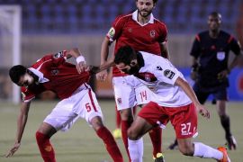 SUEZ, EGYPT - JULY 25: Momen Zakaria of Al-Ahly (L) in action against Ayman Al Tarabolse of Etoile Sportive du Sahel (R) during the Confederation of African Football (CAF) Confederation Cup match between Etoile Sportive du Sahel and Al-Ahly at Suez Stadium in Suez, Egypt on July 25, 2015.