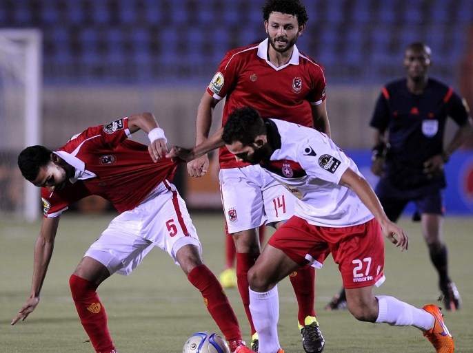 SUEZ, EGYPT - JULY 25: Momen Zakaria of Al-Ahly (L) in action against Ayman Al Tarabolse of Etoile Sportive du Sahel (R) during the Confederation of African Football (CAF) Confederation Cup match between Etoile Sportive du Sahel and Al-Ahly at Suez Stadium in Suez, Egypt on July 25, 2015.