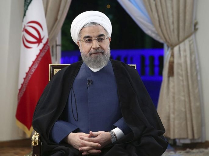 CORRECTS SOURCE IN INSTRUCTIONS In this photo released by the official website of the office of the Iranian Presidency on Sunday, Aug. 2, 2015, Iran's President Hassan Rouhani attends an interview with the state-run TV at the presidency office in Tehran, Iran. Rouhani said his country achieved its main goals in the landmark nuclear deal reached with world powers last month and that the accord recognizes Iran's right to enrich uranium and lifts international sanctions. (Iranian Presidency Office via AP)